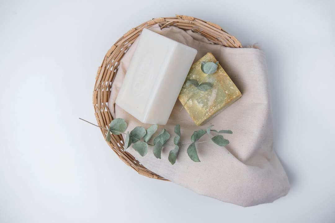Handmade soap bars curing on a wooden shelf