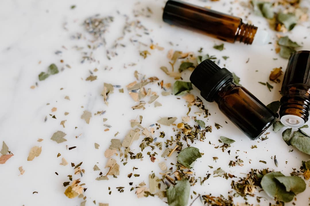 Bottles of aromatic oils lined up for blending a custom cologne scent