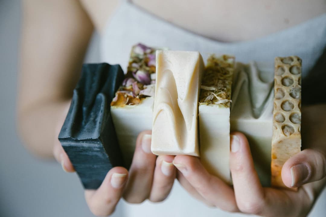 A variety of handmade soap bars in different colors and styles