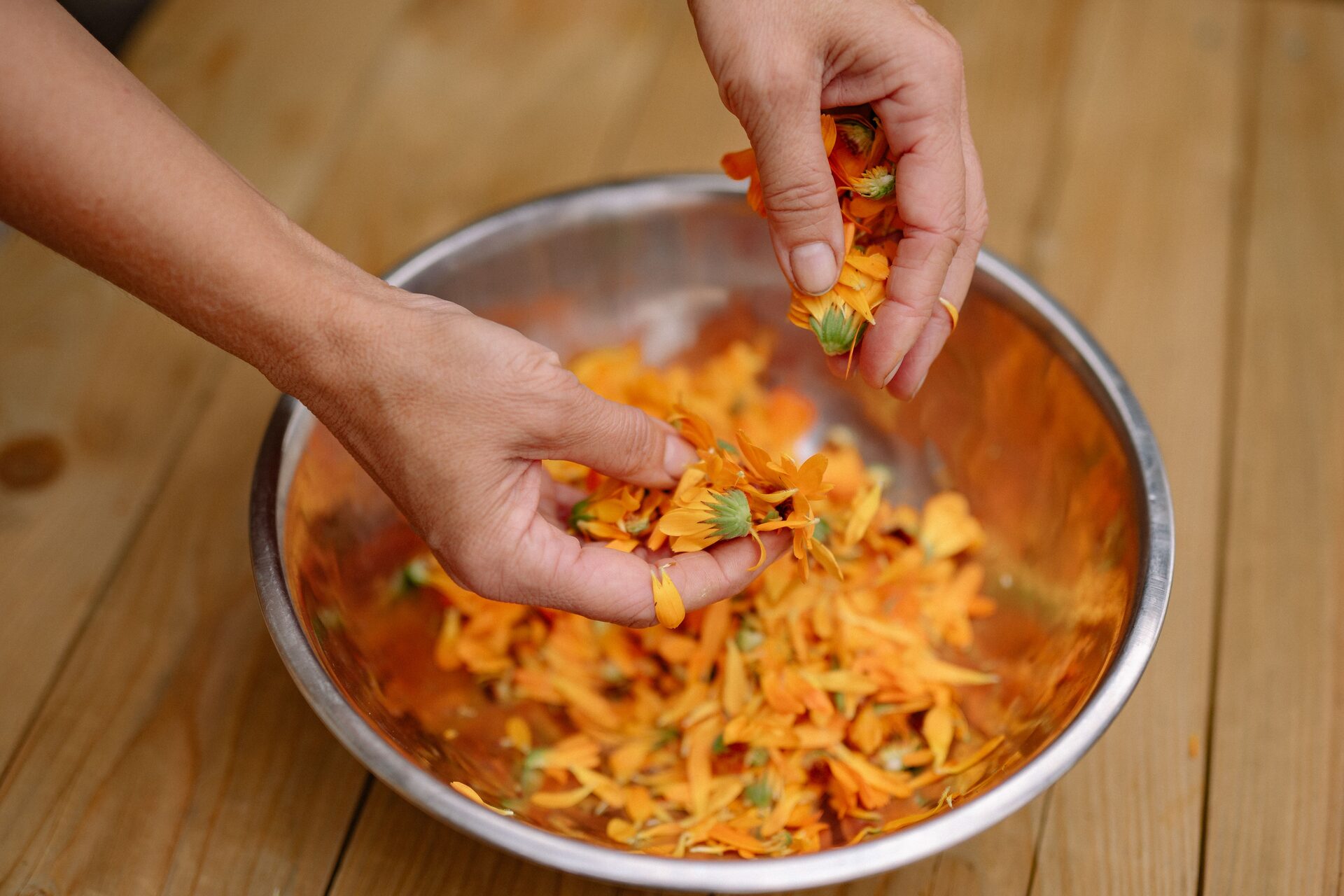 Calendula flowers infusing in oil in a glass jar