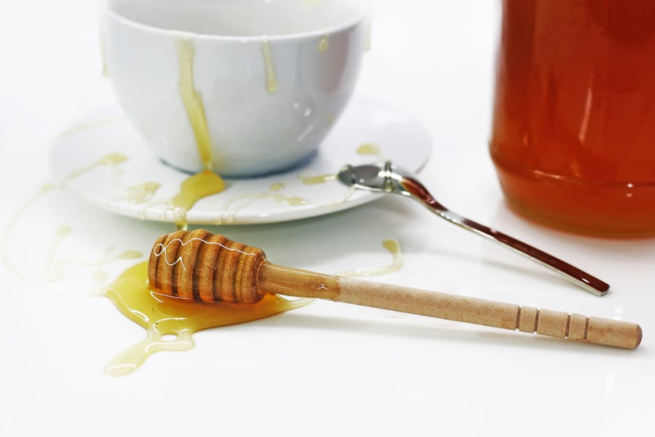 Golden honey dripping from a spoon