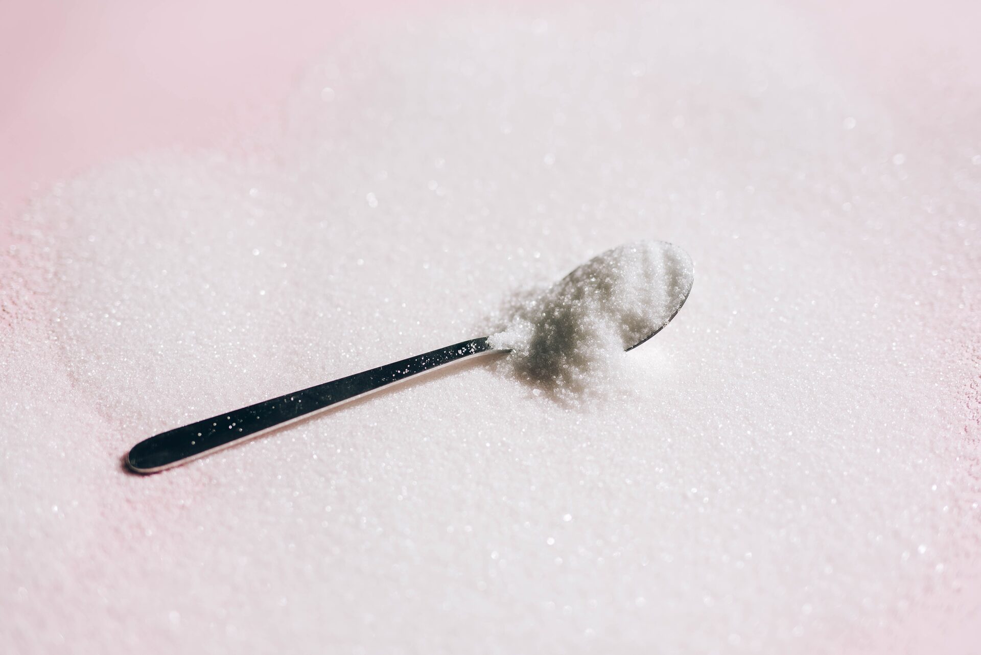 White sugar in a bowl with a spoon